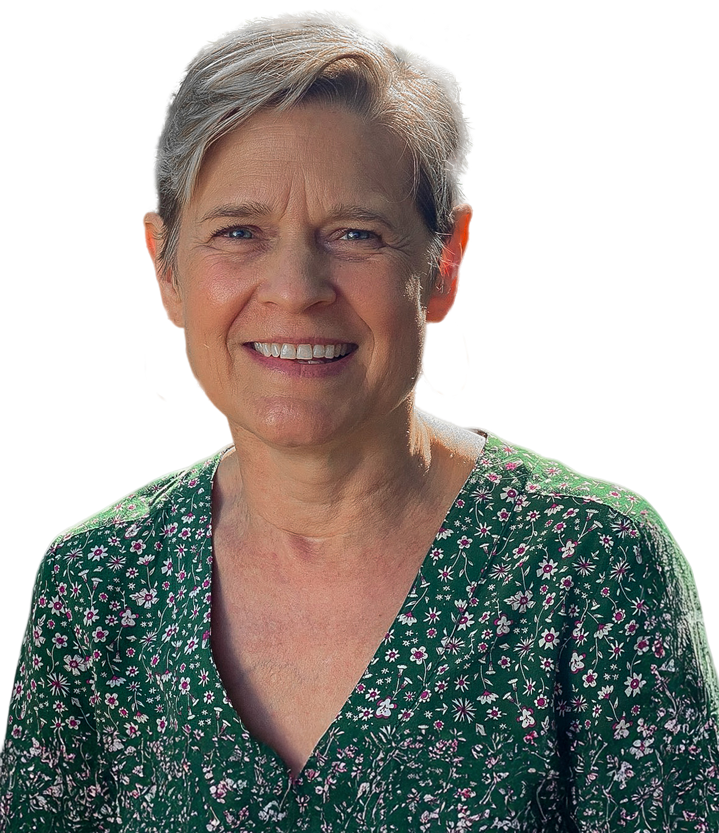 A woman with short light hair wearing a green floral-patterned top, smiling against a white background.