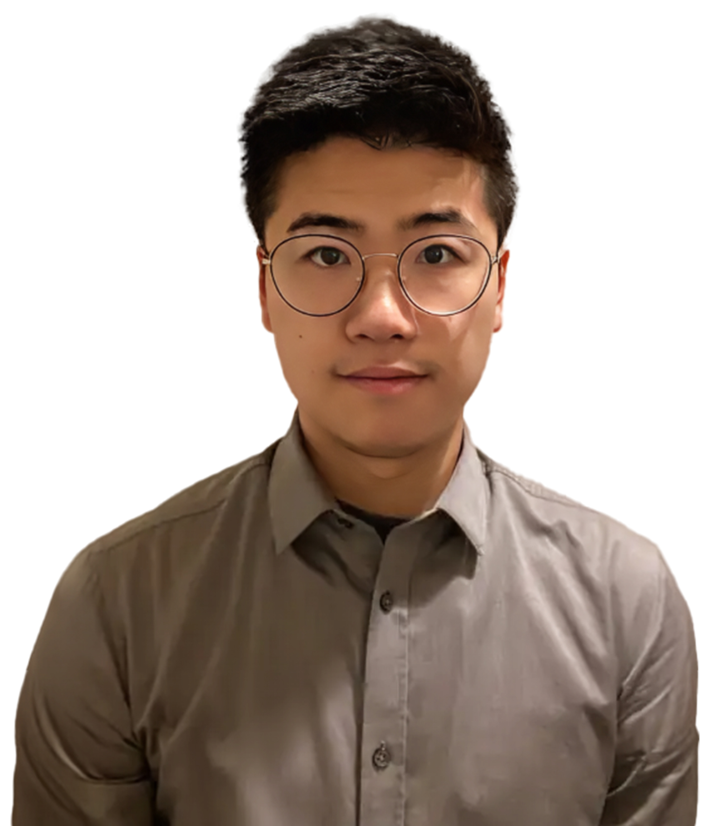 A man with short dark hair and glasses wearing a gray button-down shirt, looking at the camera against a white background.