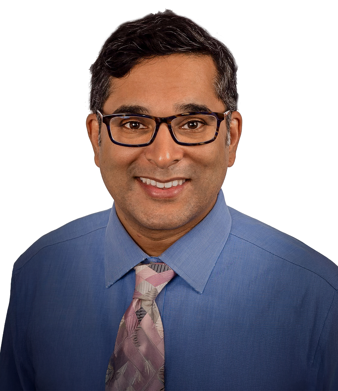 A man with short dark hair wearing glasses, a blue dress shirt, and a patterned pink and gray tie, smiling against a white background.