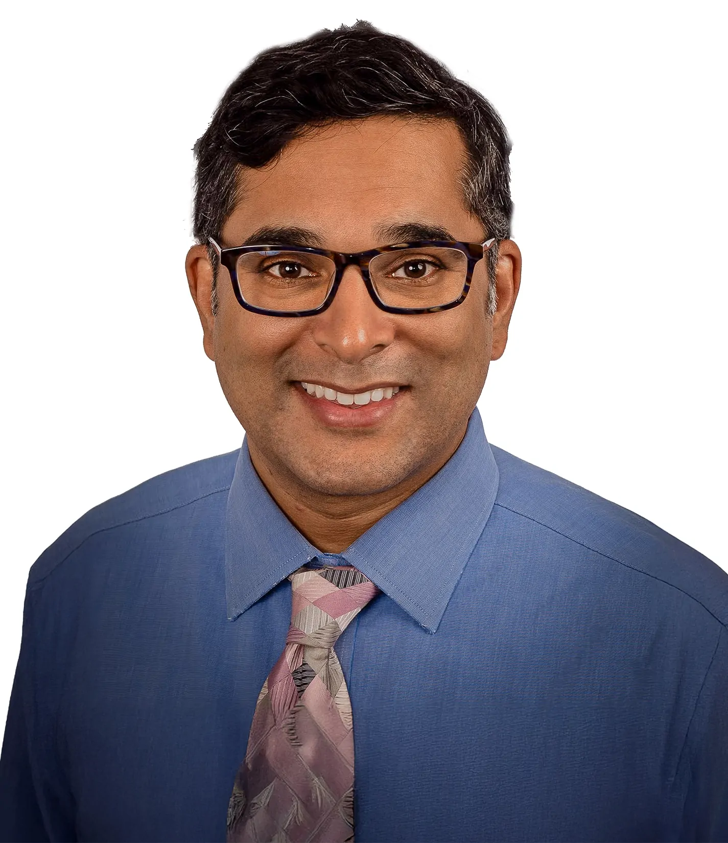 A man with short dark hair wearing glasses, a blue dress shirt, and a patterned pink and gray tie, smiling against a white background.