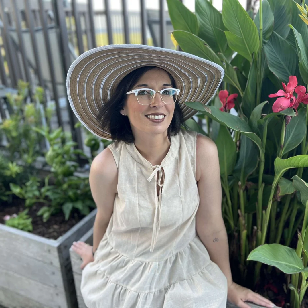 Brandi Wiseman pictured smiling while seated on a bench outdoors.