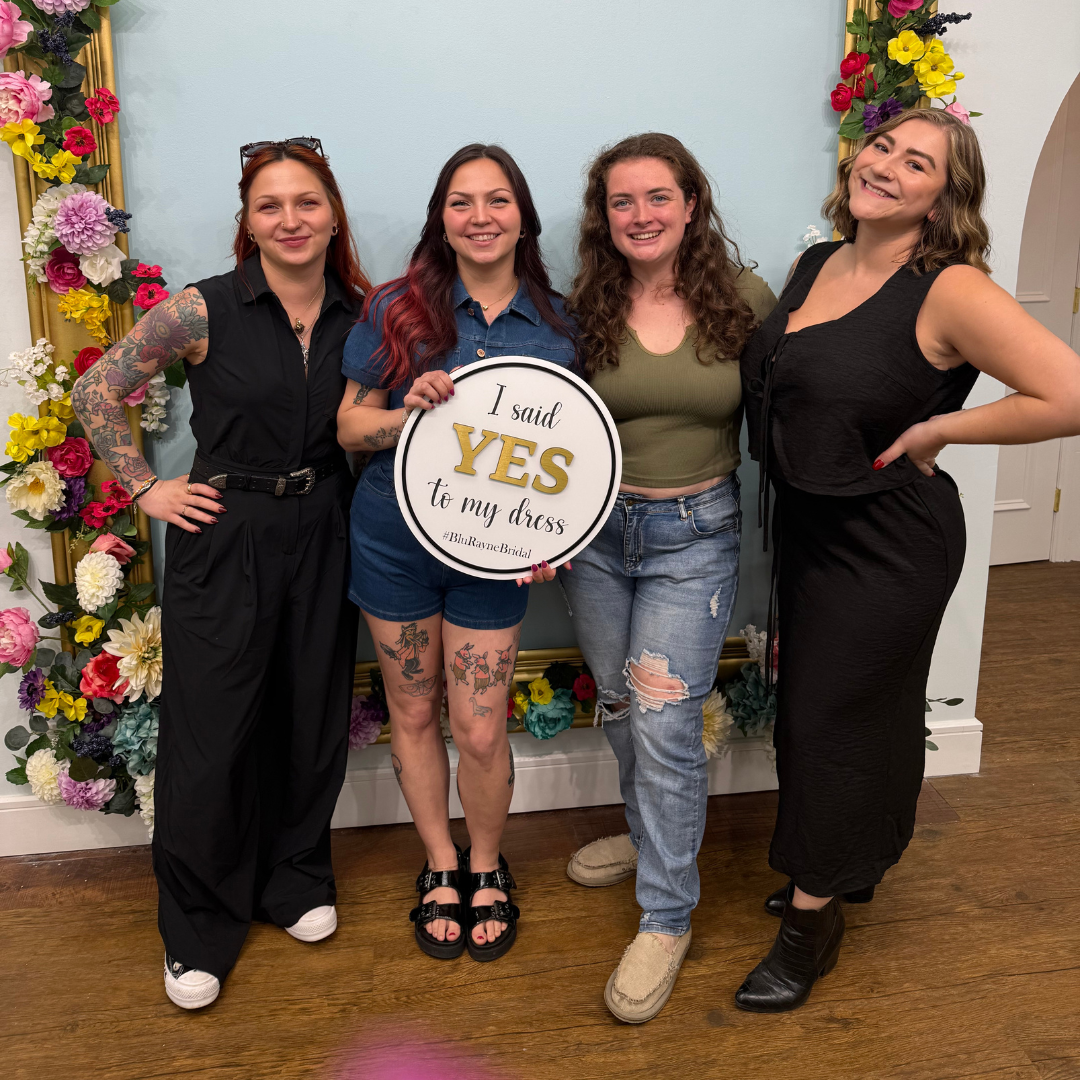 Madelyn pictured indoors, surrounded by loved ones, with a "I Said Yes to the Dress!" sign.