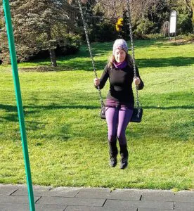 Rosy outside on a swingset