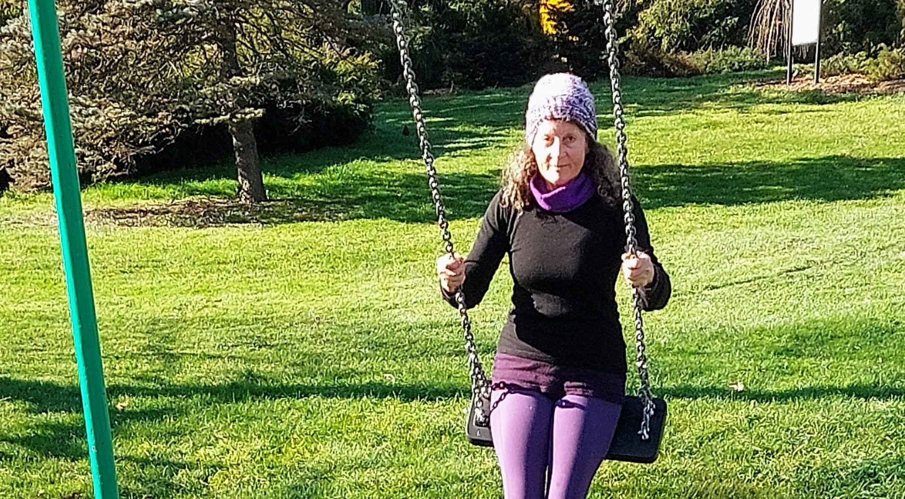 Rosy outside on a swing set