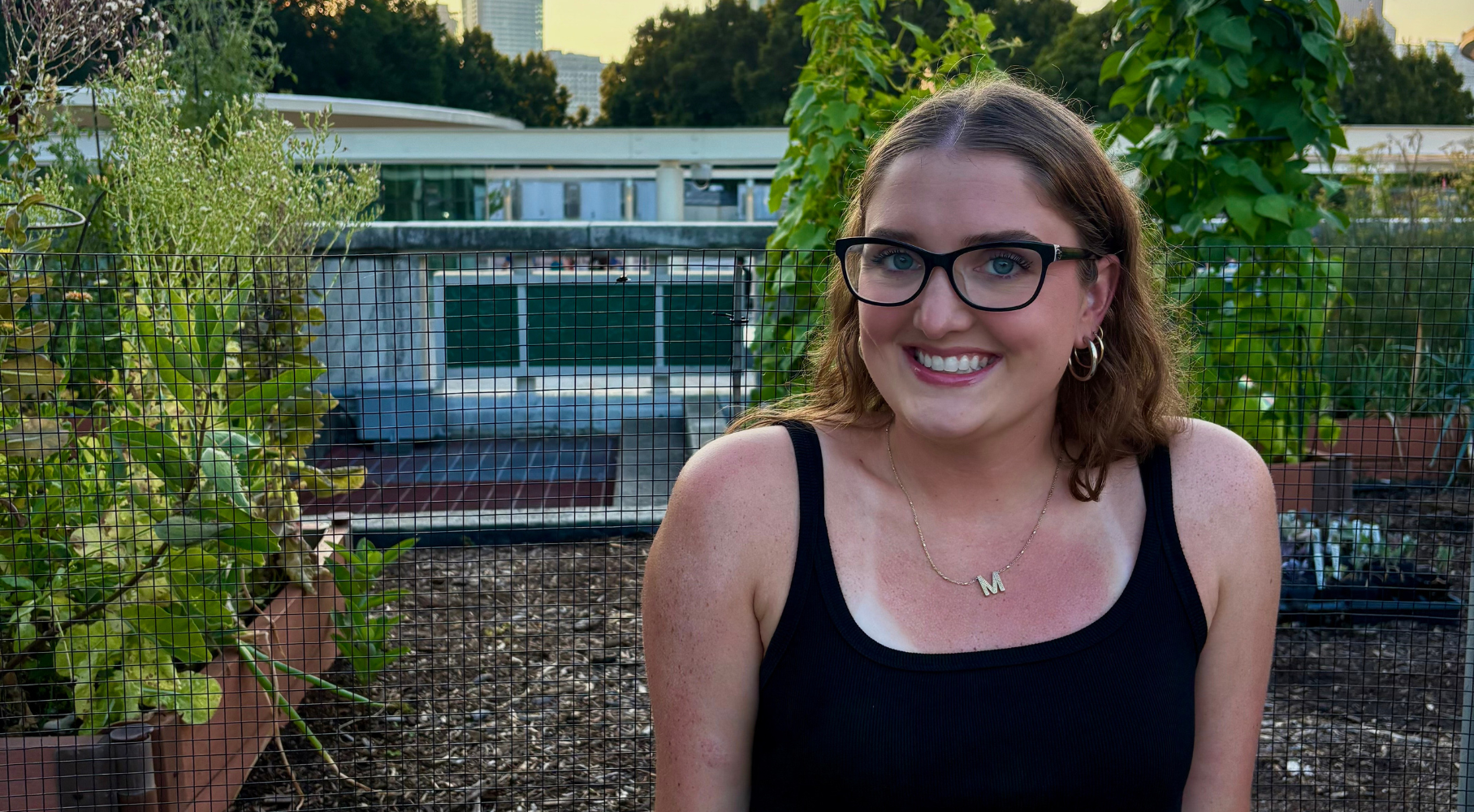 Madeleine smiling outside in the garden