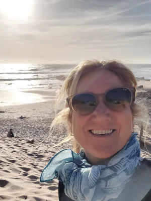 Alejandra smiling outside at the beach