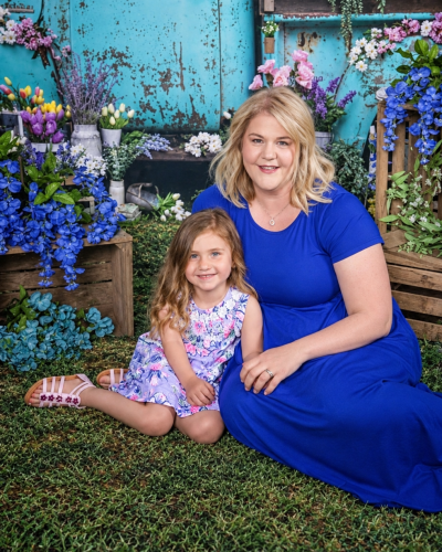 Tasha and child pictured together infront of truck and flowers